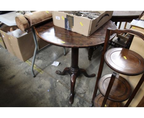 An antique snap top table raised on tripod base