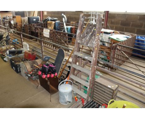 A step ladder, galvanised watering can AF, rake attachment