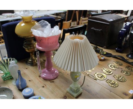 An onyx table lamp; brass oil lamp and a glass lustre with prism drop