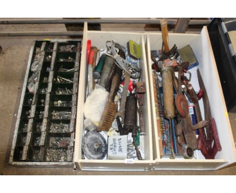 Two drawers of various hand tools together with a wall mounted nest of drawers with contents of various bolts and washers