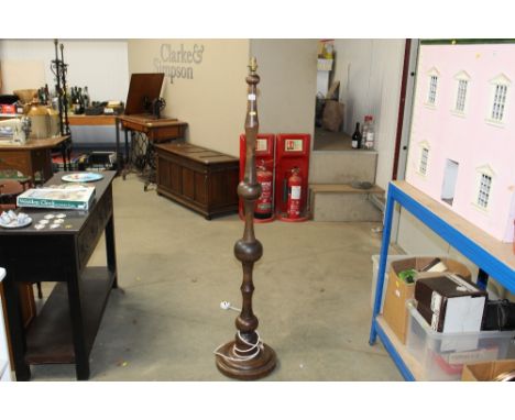 A turned wooden standard lamp 