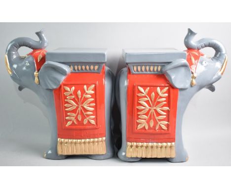 A Pair of Painted Ceramic Stands in the Form of Elephants, 32cms High