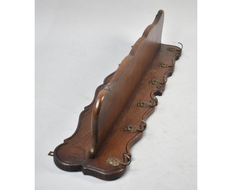 An Oak Wall Hanging Coat Rack with Galleried Back and Top Shelf, 108cms Wide