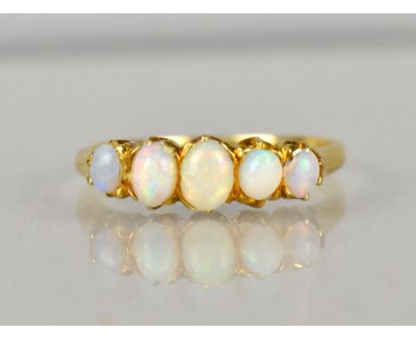 An Early 20th Century Opal Dress Ring comprising Five Graduated Oval Opal Cabochon, Largest 2.9mm by 4.3mm, Smallest 1.9mm by