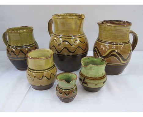 Sidney Tustin for Winchcombe pottery jug in green and brown glaze, 9.5cm high, Winchcombe pottery miniature jug marked 'DI(?)