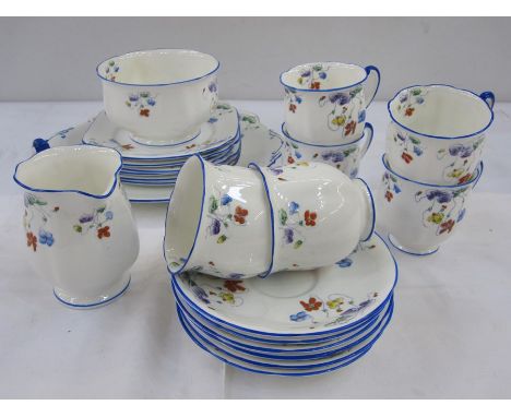 Standard china part tea service comprising of six cups, saucers, plates, slop bowl and milk jug, floral decorated with blue b