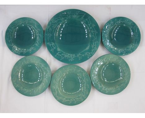 Set of five Ashtead turquoise pottery plates and matching charger with running deer to rim of plates in relief, marked to bas