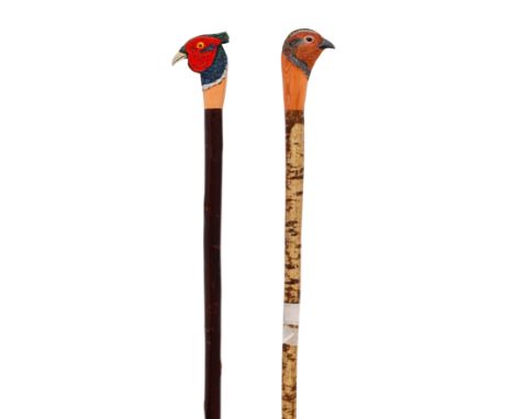 Two carved sporting staffs by Mark RichardsThe first a cock pheasant, the second a hen pheasantBoth approx. 53in. in length(2
