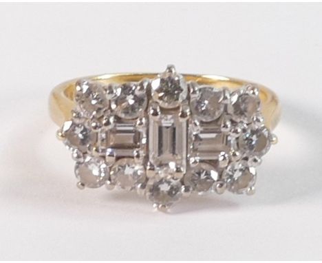 18ct gold diamond cluster ring, three central baguette diamonds surrounded by twelve brilliant cut diamonds, 4.9g. insurance 