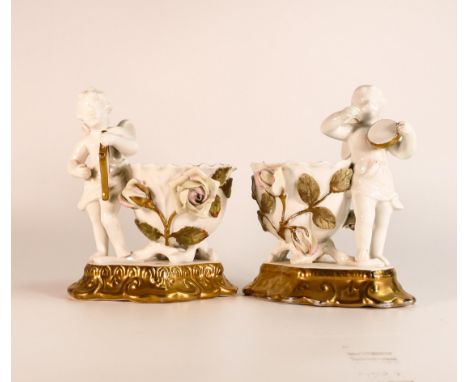 James Shaw &amp; Sons, pair of small vases, with applied naturalistic roses to vase flanked by Putti holding a harp and drum.