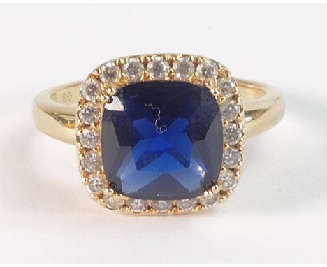 Dress ring, set with large blue paste stone surrounded by cz, yellow metal and tested to be 9ct or higher, size R, 4.2g. 