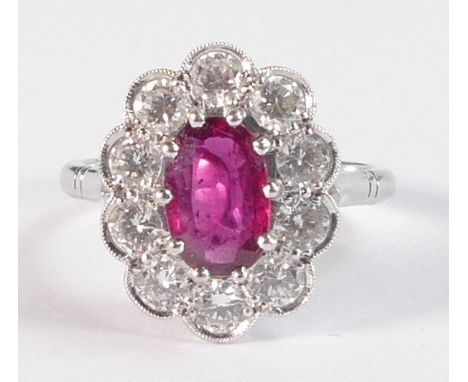 18ct white gold ruby and diamond cluster ring, set with central oval cut ruby (9mm x 5.8mm x 2.2mm, approx. 0.92ct) surrounde