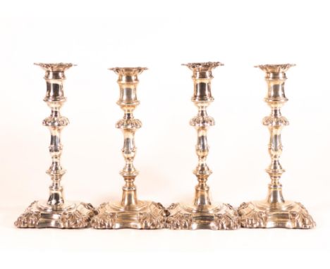 Set of four Rococo decorated silver candlesticks (two very near identical pairs), all by the same maker, Henry Wilkinson &amp