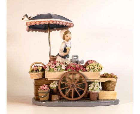 Lladro porcelain 'Flowers of the Season' figure,by José Puche, printed marks, no. 1454, 24.5cm wide 26cm high, missing bird f