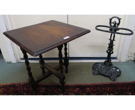 A cast iron stick stand and an oak barley twist occasional table (2) Condition Report: Available upon request