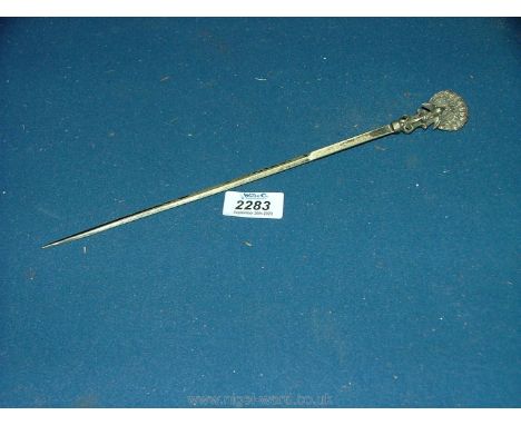 An Indian white metal skewer with peacock finial.