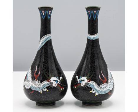 A pair of Chinese cloisonné enamel vases, c.1900. Each of pear shape and decorated with a ferocious dragon picked out in whit