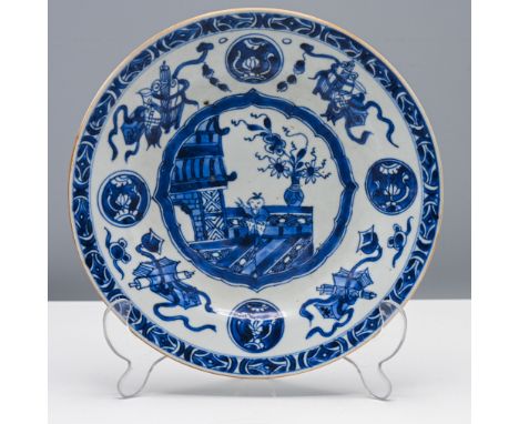 A blue and white plate, Qing dynasty, Kangxi (1662-1722) Painted with a central shaped medallion of a boy standing in a terra
