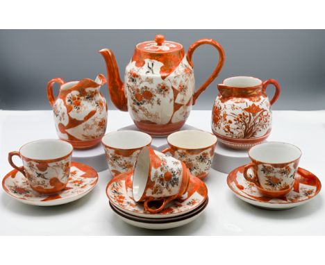 A Japanese Kutani ware coffee set, Meiji period or later. Decorated with over-lapping shaped panels of floral sprigs reserved