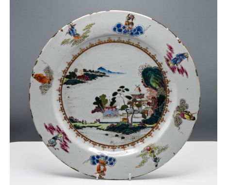 A "famille-rose," Charger, Qianlong," finely painted with pavilions in a lake landscape encircled by a spearhead border in a 