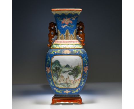 A ‘famille-rose’ blue ground scraffiato wall vase, 19th century, the ovoid body with a landscape panel on a stepped base and 