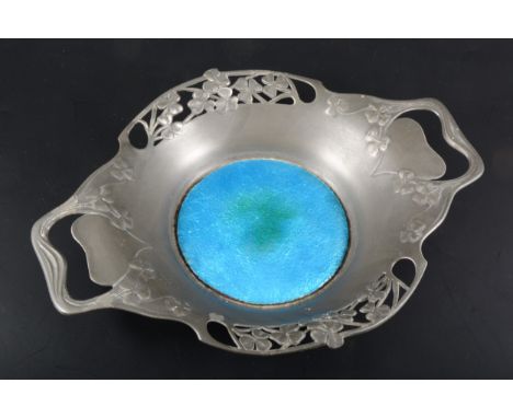 An Arts and Crafts 'Tudric' pewter and enamel dish, by Liberty &amp; Co., the pierced border cast with flowers, the well inse