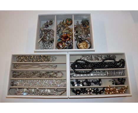 Three trays with modern jewellery including silver charm bracelet, 925 silver bangle, white metal necklaces, costume brooches