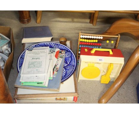 A print depicting the Orwell bridge; various books; blue and white serving platter; Fisher Price children's toys etc