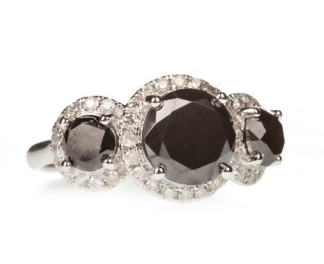 BLACK GEM AND DIAMOND RING, the three round black gems within diamond halos, the diamonds totalling approximately 0.41 carats