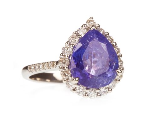 TANZANITE AND DIAMOND RING, the pear shaped tanzanite of approximately 4.17 carats within a halo of round brilliant cut diamo