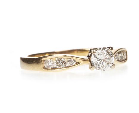 DIAMOND DRESS RING, the round brilliant cut diamond of approximately 0.35 carats, flanked by three smaller diamonds on each s