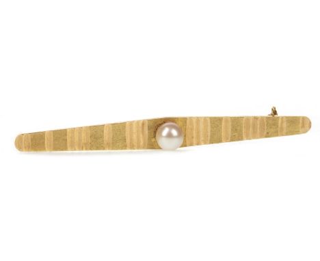 PEARL SET BROOCH, with engraved decoration, set with a spherical pearl, 61mm long, marked 750 to the reverse, 4.5g