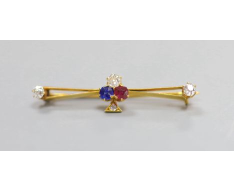   An Edwardian yellow metal, ruby, sapphire and diamond set clover bar brooch,39mm, gross weight 3 grams.