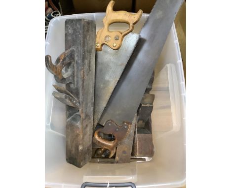   A collection of vintage tools including woodworker's planes and saws