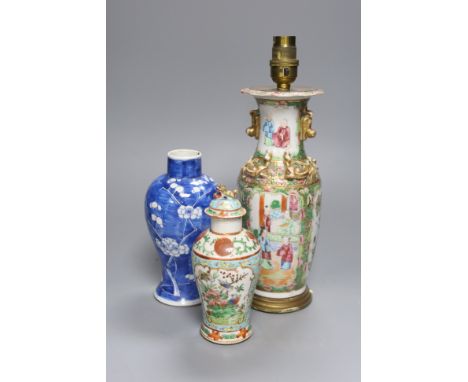   A Chinese famille rose converted lamp, a similar blue and white vase and another vase and cover, overall height 32cm