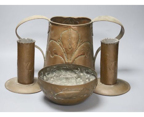   A Newlyn copper 'fish' bowl, together with a pair of Art Nouveau planished copper candlesticks and a similar two handled ju