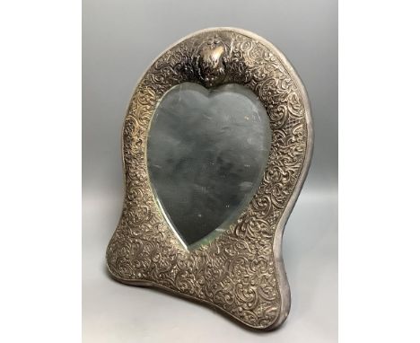   A late Victorian repousse silver mounted easel mirror with heart shaped plate, Henry Matthews, Birmingham, 1893, 35cm.