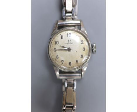   A lady's stainless steel Omega manual wind wrist watch, on associated flexible bracelet.