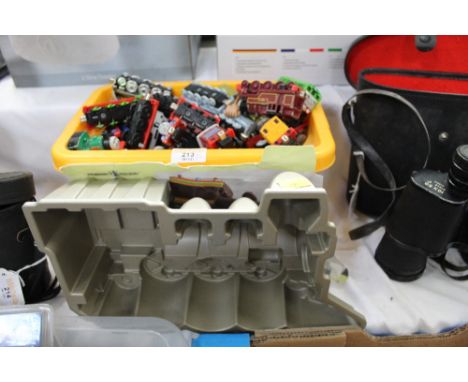 Box of diecast Thomas The Tank Engine engines and a locomotive cake pan