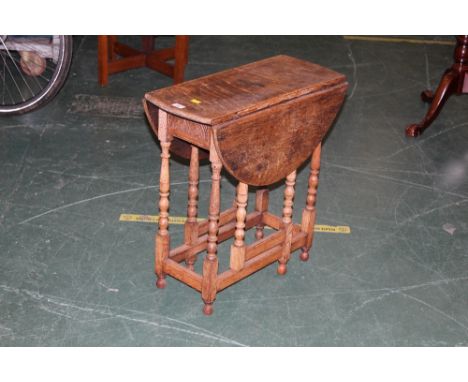 An oak drop leaf and gate leg table