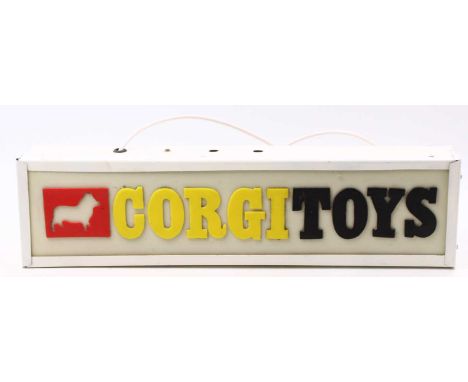 A vintage Corgi Toys illuminating shop sign comprising a metal case with a plastic front and Corgi Toys text, overpainted in 