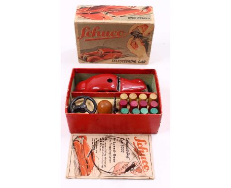 Shuco 3000 clockwork Telesteering four-speed gear car in red body with accessories, housed in an original pictorial box with 