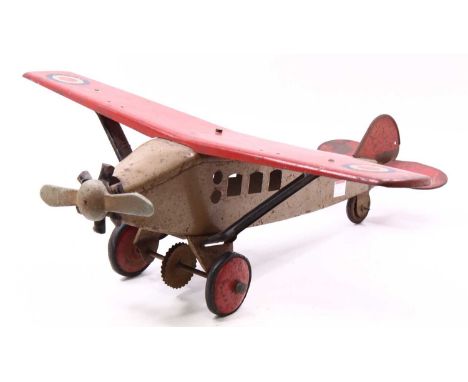 A Triang Toys large pressed steel aircraft comprising of tan body with red wings, complete with RAF roundels, complete with o