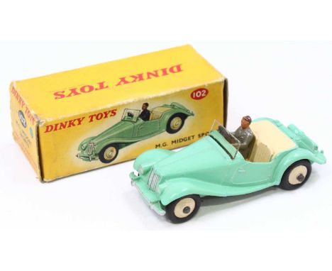 Dinky Toys No. 102 MG Midget sports car comprising light green body with cream interior and cream hubs and driver figure, in 