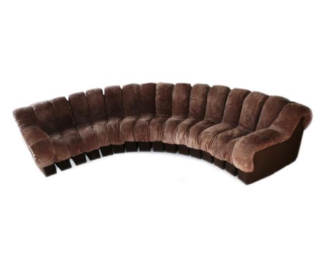 A 1970's Brown Suede and Felt Segmented Caterpillar Sofa, in the manner of De Sede, in two sections, with rounded back suppor