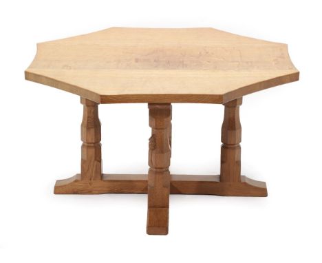 Mouseman: A Robert Thompson of Kilburn English Oak Octagonal Table, on four octagonal legs joined by a X stretcher, with carv