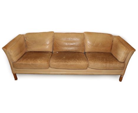 A 1970's Light Tan Leather Three-Seater Sofa, with slender arms above stained brown square form legs, 218cm by 76cm by 66cm