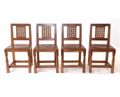 Mouseman: A Set of Four Robert Thompson of Kilburn English Oak Lattice Back Dining Chairs, with brown hide seats, each with c