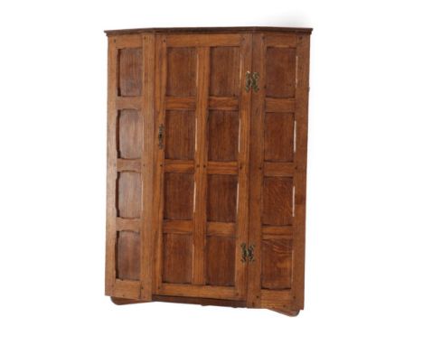 A Sid Pollard of Thirsk English Oak Hanging Corner Cupboard, the panelled door opening to reveal two shelves, on a bracket, u