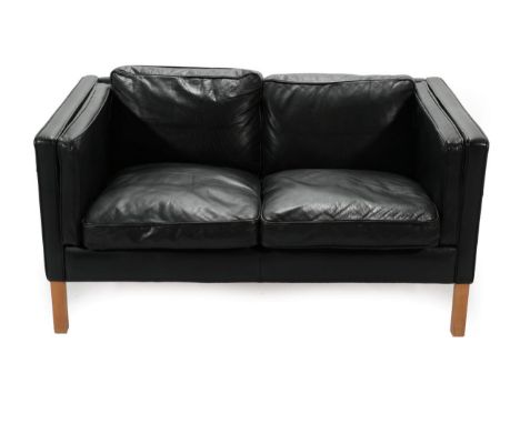 A 1970's Danish Stouby Two-Seater Sofa, upholstered in black leather, with six cushions, 132cm by 83cm by 72cm 